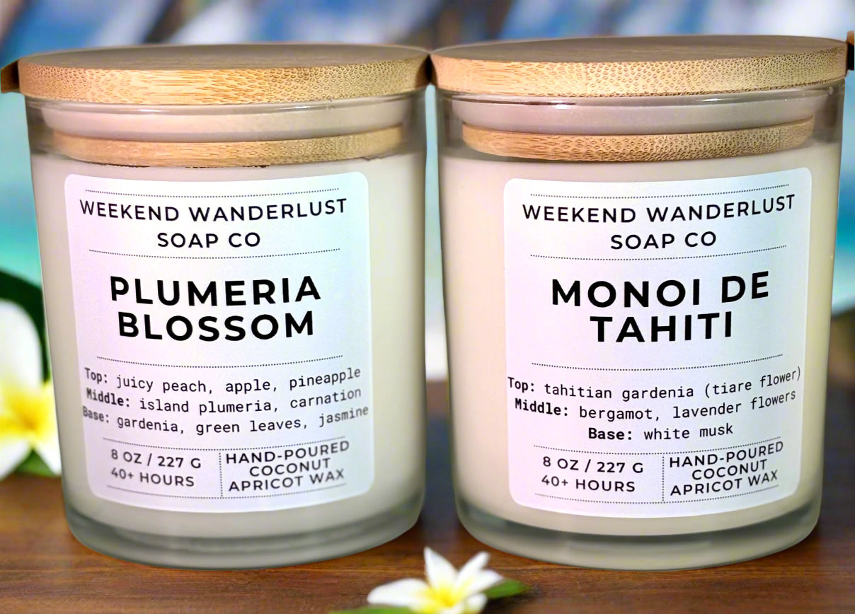 Two candles from Weekend Wanderlust Soap Co with labels on a neutral background
