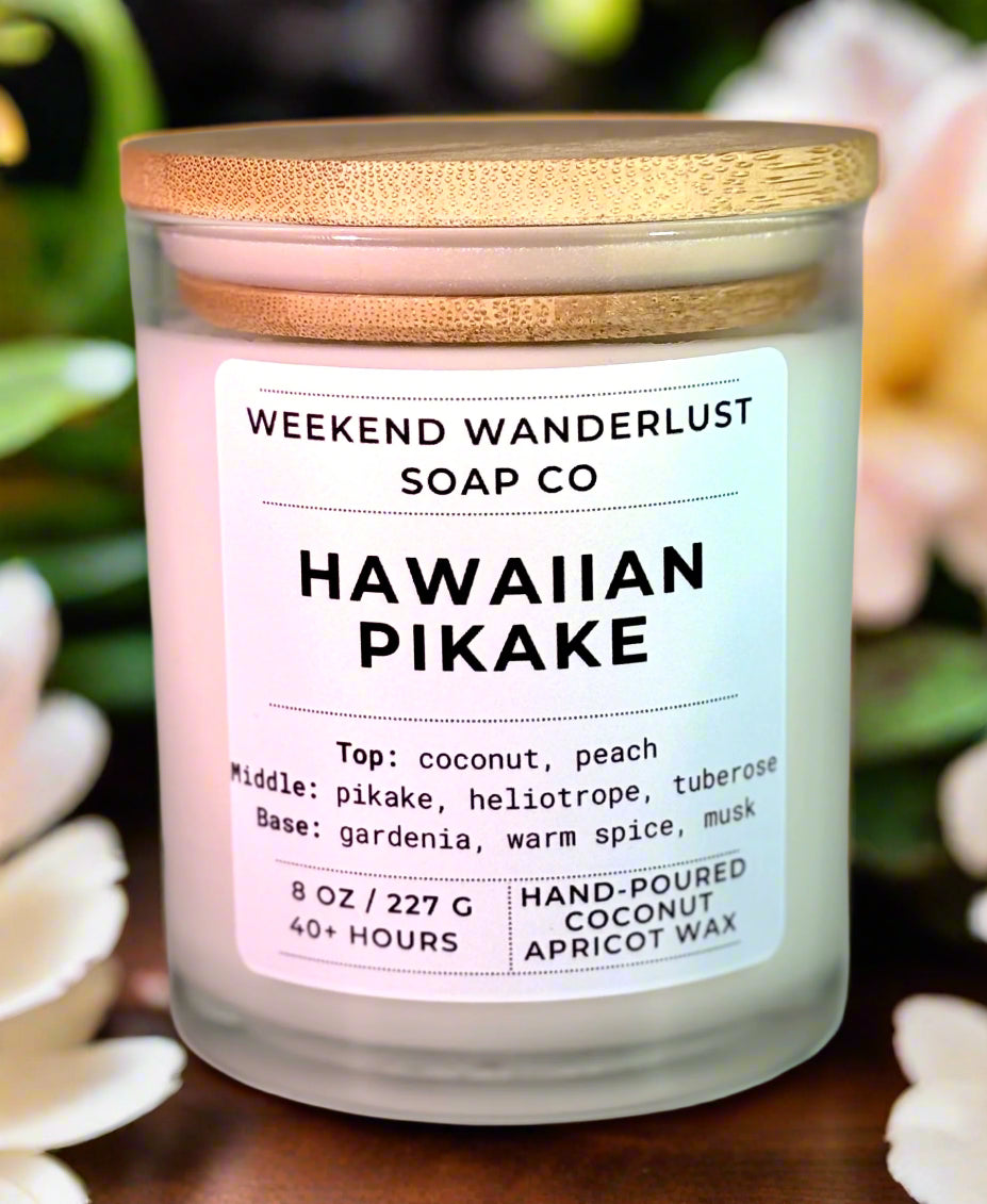 Candle labeled 'Hawaiian Pikake' from Weekend Wanderlust Soap Co with a wooden lid.