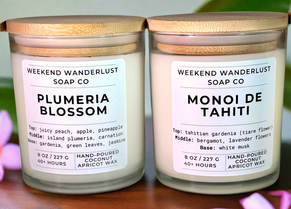 Two candles from Weekend Wanderlust Soap Co with labels on a neutral background