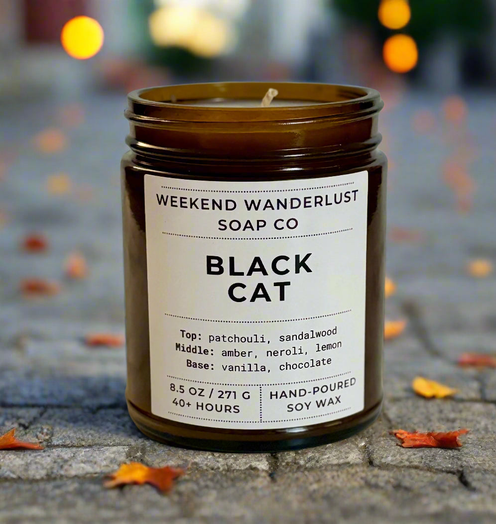 Candle jar with 'Weekend Wanderlust Soap Co' label on a marble surface