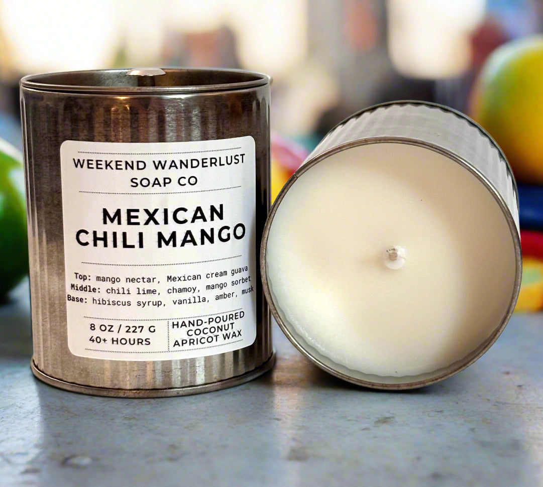 Candle in a metal tin with a label for 'Weekend Wanderlust Soap Co. Mexican Chili Mango' on a white background.