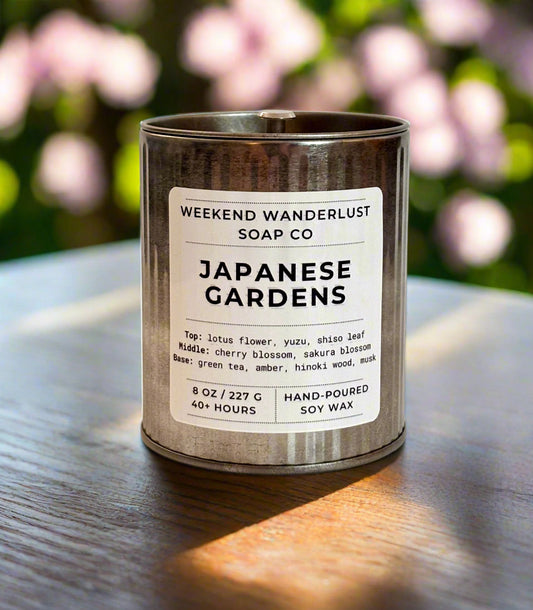 Candle in a tin with 'Weekend Wanderlust Soap Co' label on a white background