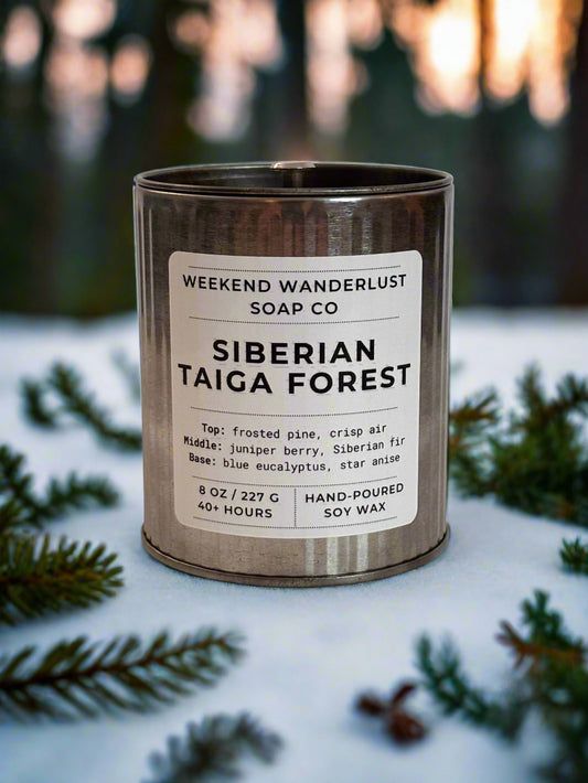 Candle in a tin with 'Weekend Wanderlust Soap Co' label on a light background