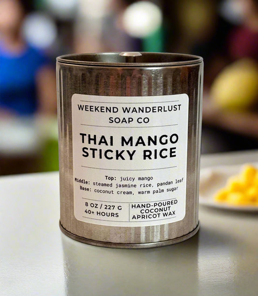 Candle in a tin with 'Weekend Wanderlust Soap Co' label on a light background