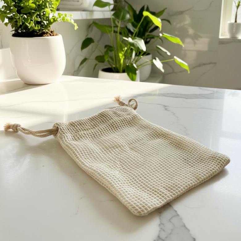 Woven cloth bag on a marble surface with plants in the background